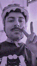 a selfie of a white person, wearing either headphones or a helmet, making an odd expression. the photo is edited to be colorized into a monochrome purple-ish color palette.